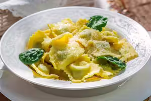 Ravioli mit sonnengetrockneten tomaten, ricotta und italienischem schinken